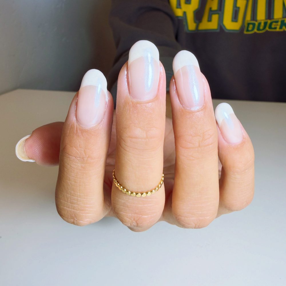 A long almond extension set with a crisp white French tip.