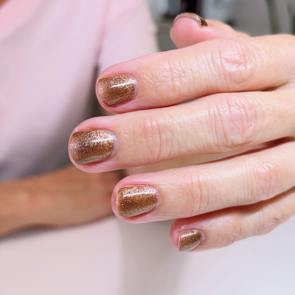 Copper glitter gel on short natural nails.