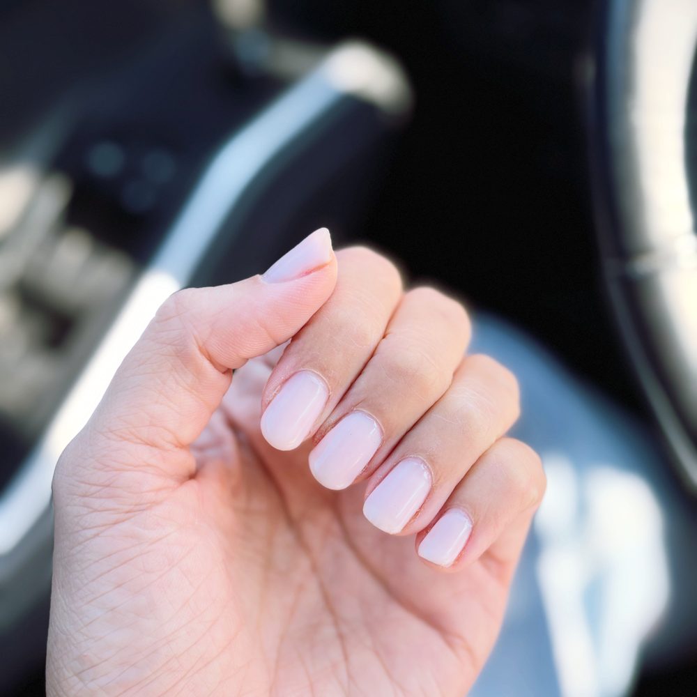 A soft pink Gel-X set, squared off at a short-to-medium length.