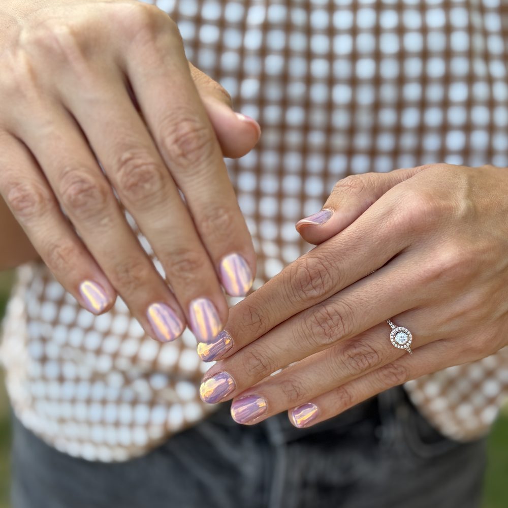 A pearl-pink structured gel manicure on short natural nails.